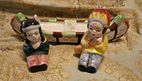 Indian couple in canoe, salt and pepper shakers