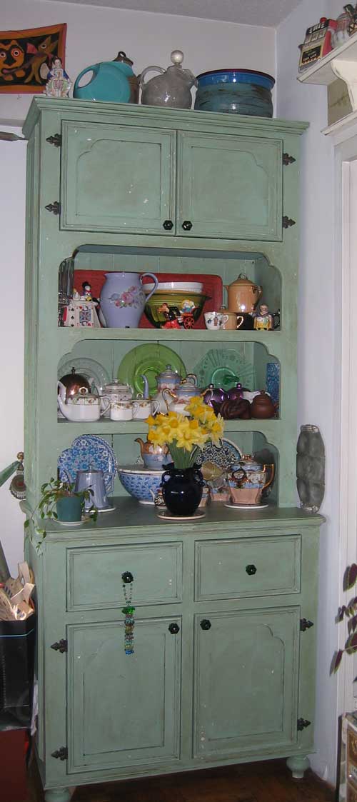 Green cabinet with shelves and drawers